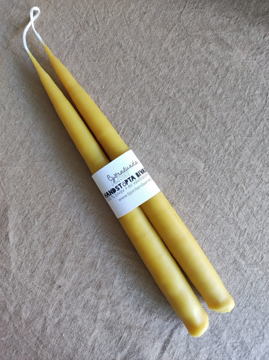 A bare beeswax candle Honey
